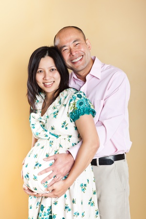 A shot of a beautiful pregnant Asian woman with her husbandの写真素材
