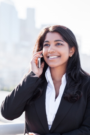 A shot of an Indian businesswoman talking on the phone  outdoorの写真素材