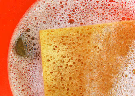 Red bucket with lather and sponge for the spring cleaningの写真素材