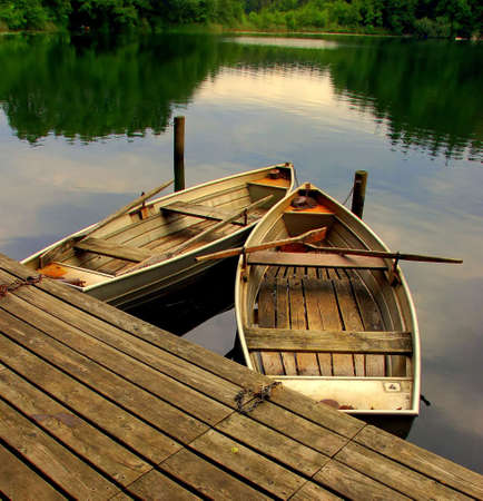 Two old rowing boats on a lakeの写真素材