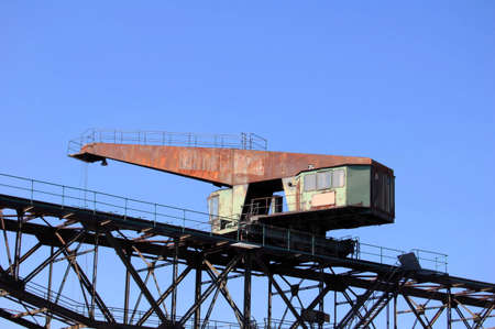 Ancient crane on a railwayの写真素材