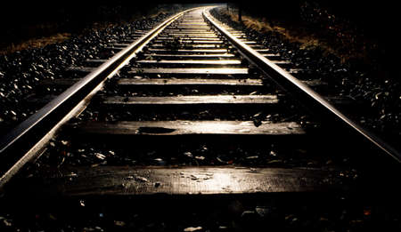 Glowing track of a railrod in back ligthの写真素材