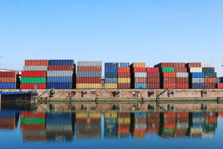 Cargo container in a harbour with water reflections