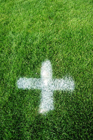 White cross on a green soccer grassの写真素材