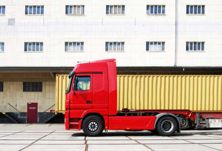 Truck and cargo container in front of a factoryの写真素材