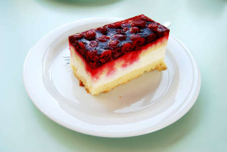 Raspberry cheese cake on a white plateの写真素材
