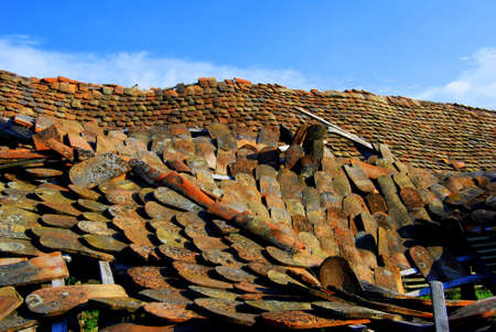 Damaged roof with colorful tilesの写真素材