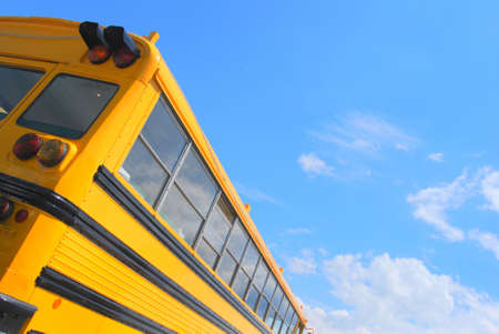 Yellow american school bus and a blue skyの写真素材
