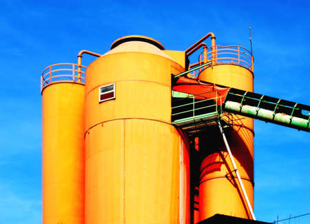 Yellow silos in a concrete plantの写真素材