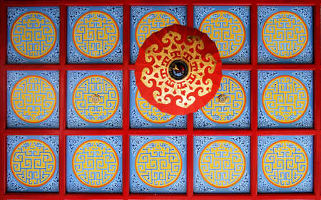 Colourful chinese painting and lamp on a ceilingの写真素材