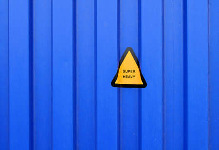 Blue sidewall of a cargo container with a super heavy signの写真素材