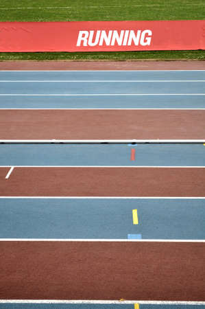 Empty red and blue striped athletic trackの写真素材