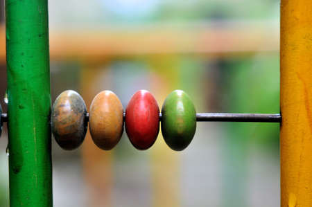 Colorful wooden marbles of a toy in a vintage playpenの写真素材