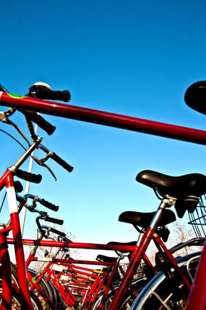 Many red bicyles in a row on a parking lotの写真素材