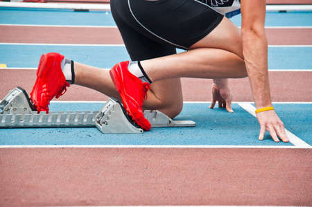 Man in starting position on an athletic trackの写真素材