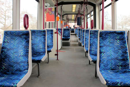 Empty wagon of a metro train with blue seatsの写真素材