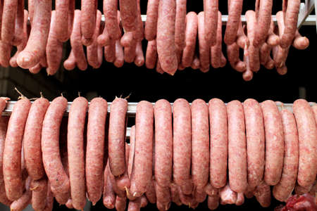 Fresh made german bratwurst hanging for dryingの写真素材