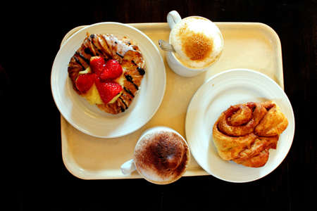 Pastry and coofee on a plate viewed from aboveの写真素材