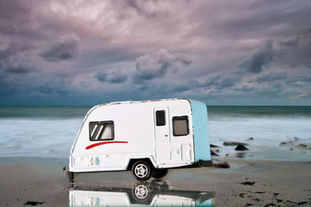 Camping car on the beach with a dramatic sky