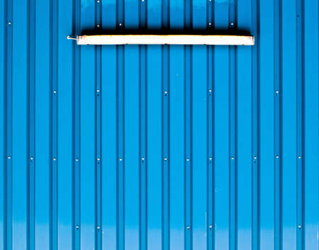 A light bulb on a blue profile claddingの写真素材