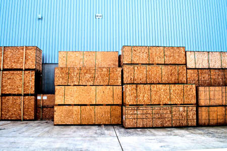 Wooden boxes for transportation and a blue cladding in a warehouse の写真素材