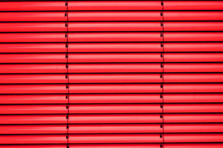 Red shutter blind in a house windowの写真素材