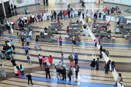 People in the arrival hall at the Johannesburg O.R. Tambo International airport in South Africaのeditorial素材