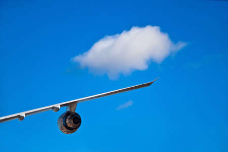 Airplane wind and turbine with a single white cloudの写真素材