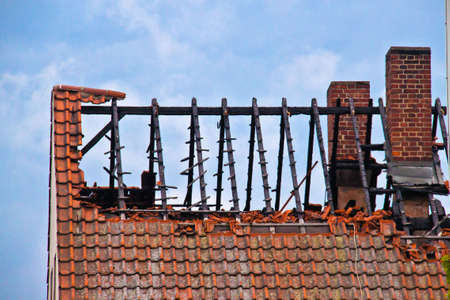 Damaged roof and missing tiles after a fireの写真素材