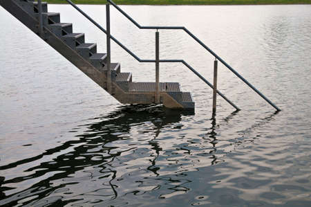 Steel staircase ending in water during flood