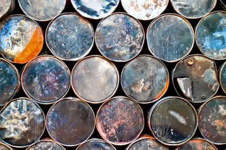 Side view of a stack of used oil drumsの写真素材