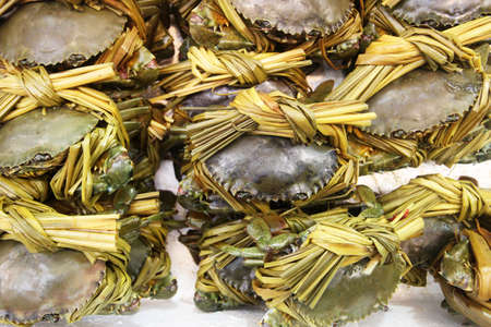 Grey crabs and bamboo stripes on ice on a plate