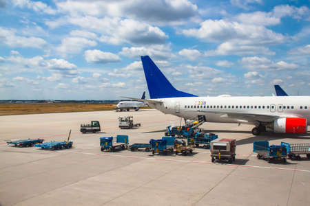 Airplanes and luggage cars on an qirport