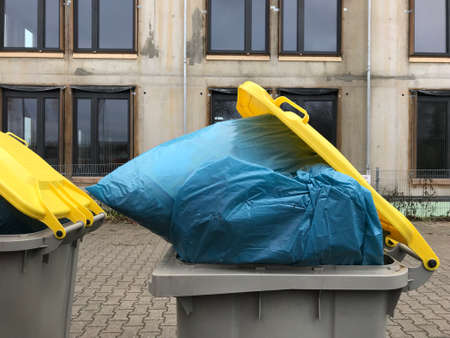 Packed garbage in plastic sacs in waste binsの写真素材