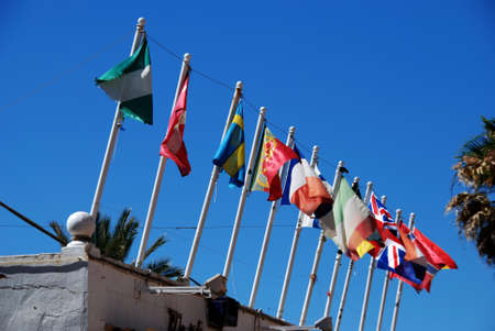 Row of flags on beach bar  chiringuito  roof, Fuengirola, Costa del Sol, Malaga Province, Andalucia, Spain, Western Europe の写真素材