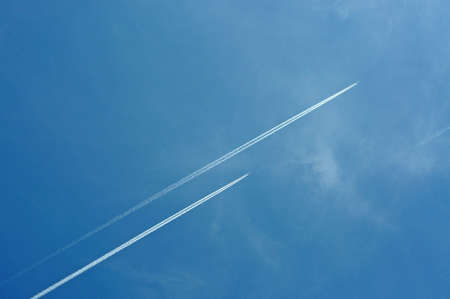 Two aeroplanes flying high in the sky leaving vapour trails, Malaga Province, Andalucia, Spain, Western Europe の写真素材