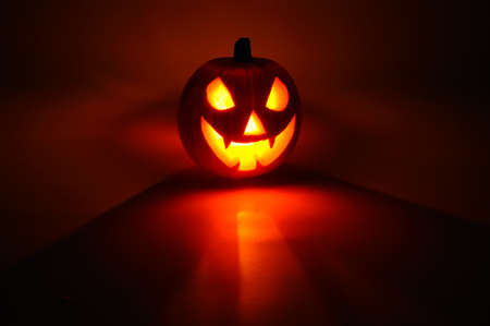 Scary face cut into pumpkin for Halloween  lit from the inside , Western Europe の写真素材