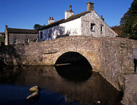 Packhorse bridge over the Malham Beck, Malham, Yorkshire Dales, North Yorkshire, England, UK,...