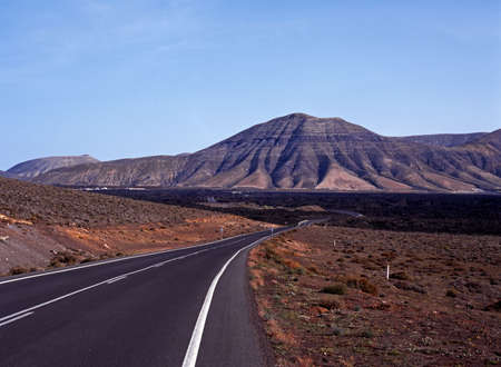 Road leading into one of the lava beds, Timanfaya National Park, Lanzarote, Canary Islands, Spain  の写真素材