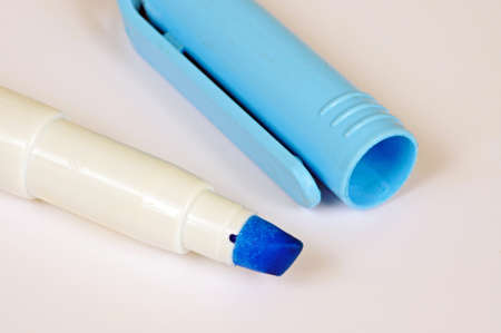 Blue highlighter pen with cap removed against a white background.の写真素材