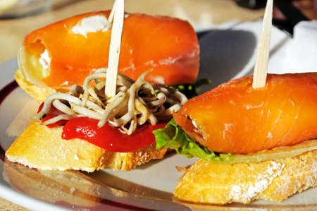 Tapas - Smoked salmon filled with cream cheese and white fish noodles with red pepper, Marbella,...