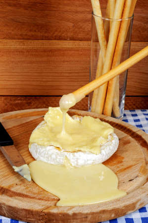 Baked whole French Camembert with Grissini breadsticks の写真素材