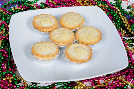 Six sugar coated mince pies and colourful beads の写真素材