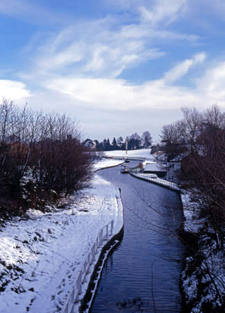 View along a snow covered canal landscape, Near Armitage, Staffordshire, England, United Kingdom, Western Europe の写真素材