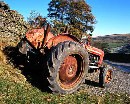 Tractor parked by a dry stone wall, Thwaite, Yorkshire Dales, North Yorkshire, England, UK, Great Britain, Western Europe の写真素材