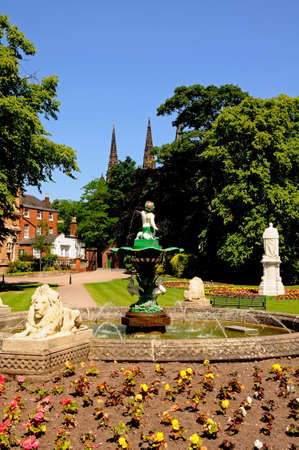 Fountain and flowerbeds in Beacon Park with the Cathedral Spires to the rear, Lichfield, Staffordshire, England, Western Europe の写真素材
