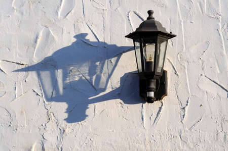Wrought iron wall light with shadow on a whitewashed wall, Costa del Sol, Malaga Province, Andalucia, Spain, Western Europe の写真素材