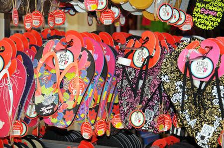 Malaga, Spain - June 14, 2011 - Colourful flip-flops on a rack outside a city centre shop, Malaga,...