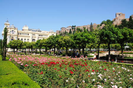 Malaga, Spain - June 14, 2011 - Town Hall along Avenida Cervantes and Jardines Pedro Luis Alonso with the Castle  Gibralfaro  Alcazaba de Malaga  to the right hand side, Malaga, Costa del Sol, Malaga Province, Andalucia, Spain, Western Europe のeditorial素材