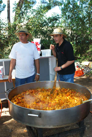 Marbella, Spain - June 8, 2008 - Men cooking a massive paella during the Romeria San Bernabe religious festival, Marbella, Andalusia, Spain, Western Europe のeditorial素材